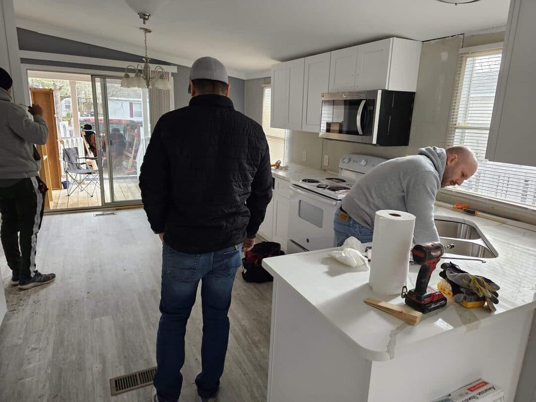 Expert craftsman installing custom kitchen cabinets